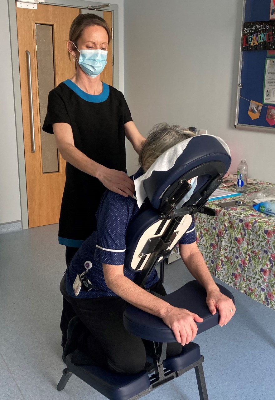 Staff member at MTW receive a chair acupressure massage