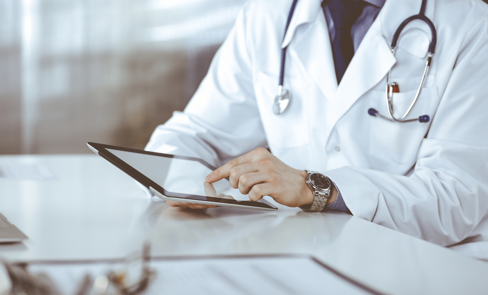 A doctor using a tablet